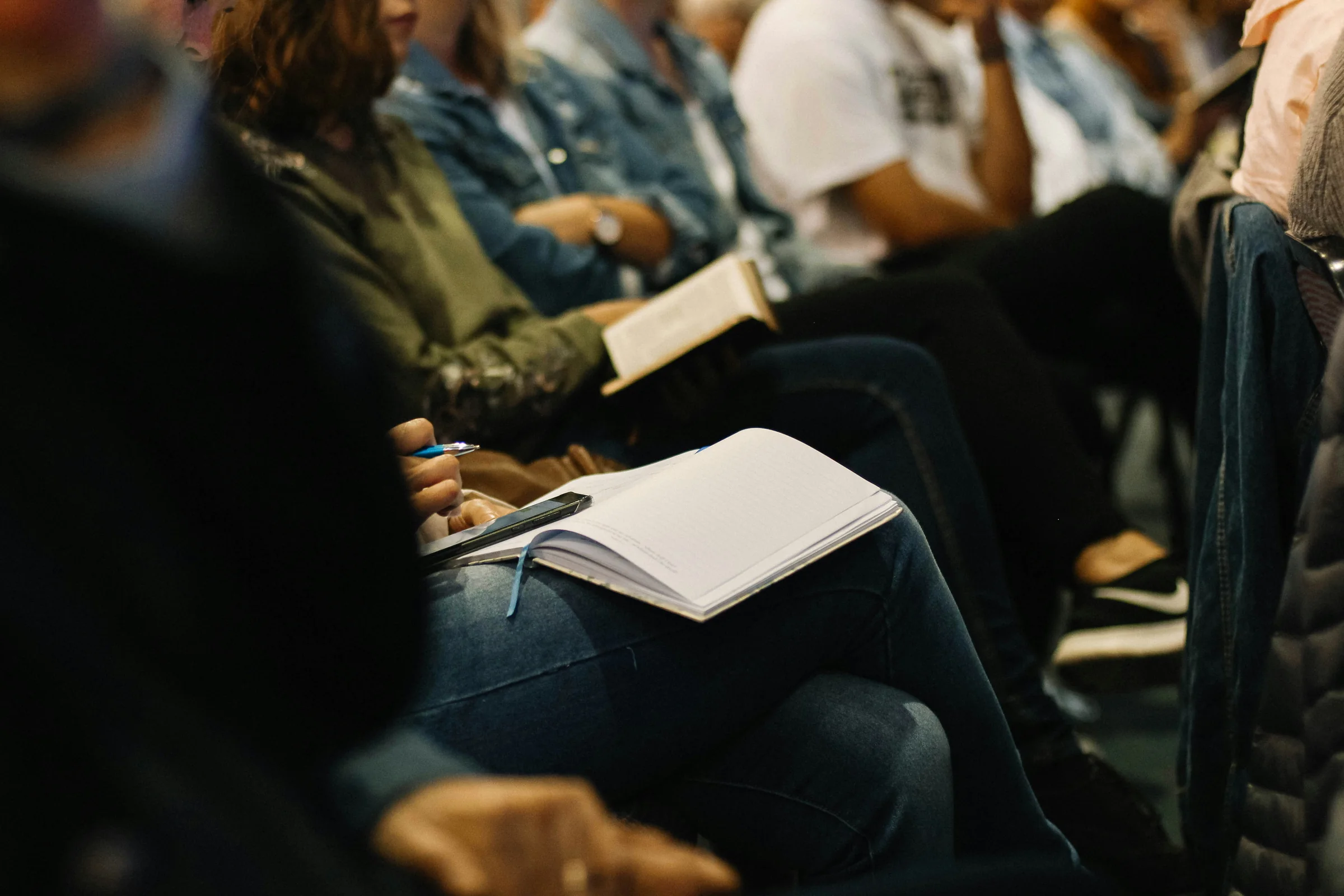 Participants taking notes at a training