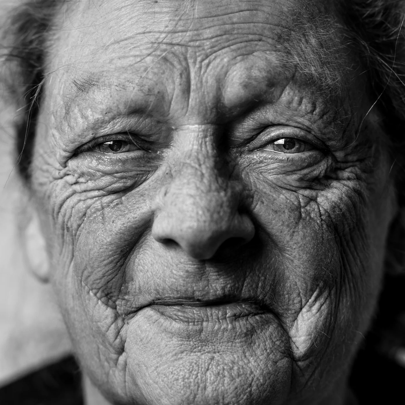Black-and-white close portrait of an older adult